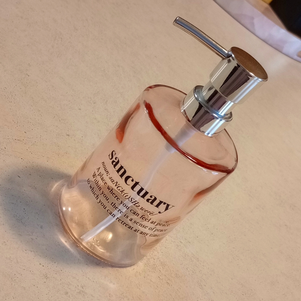 Soap Pump. Pink Glass w/ Silver Top. Black Fonts on Front.